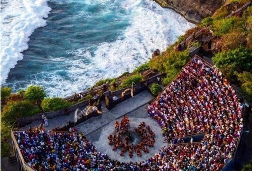 A large crowd gathered on a coastal cliff overlooking the ocean. 3