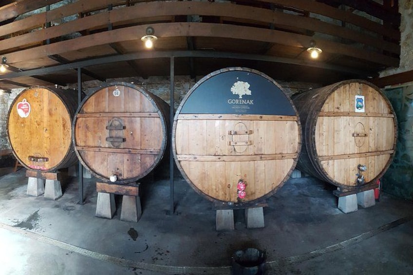 Four wooden barrels with metal stanchions, one labeled 'Gorenak'. 2