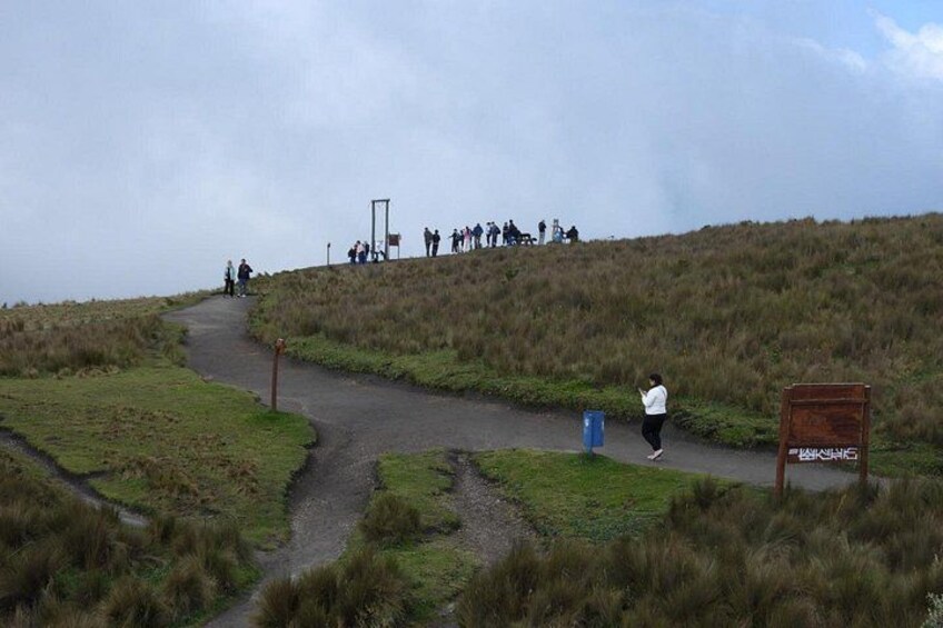 A hiking trail, grassy terrain, and a signpost. 5