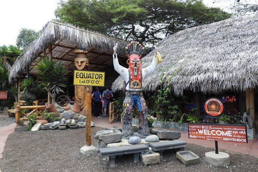 A thatched-roof structure labeled 'Equator Lat. 0°0°' with a statue of a figure holding a staff. 4