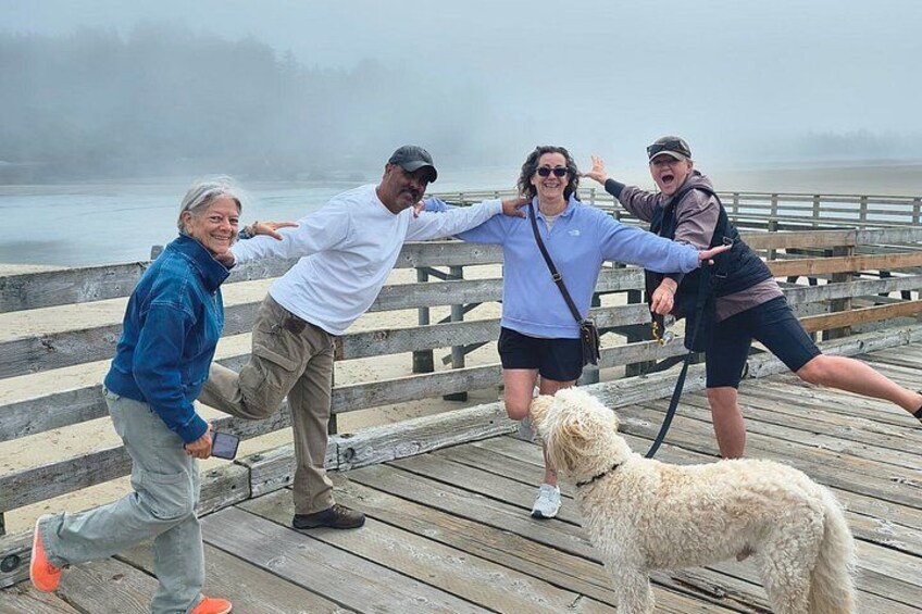 A wooden pier with people and a dog. 2