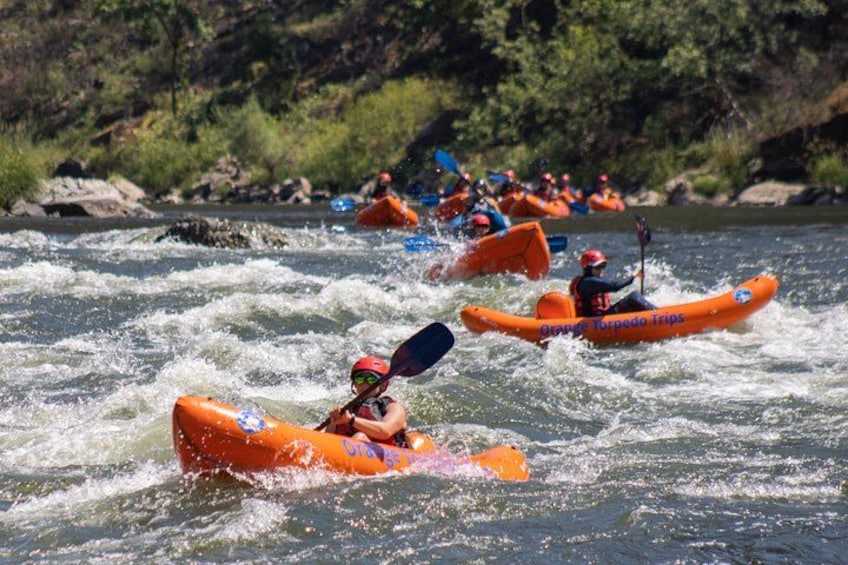 A group of people kayaking on a river. 1