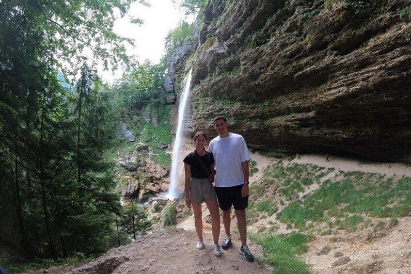 A waterfall, rocky cliffs, and a forested area. 5