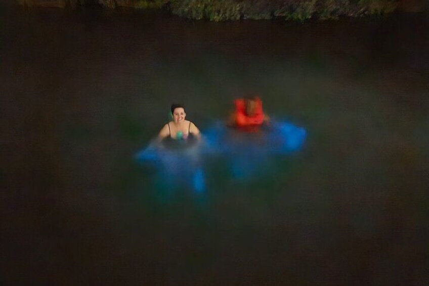 A person floating in water with a red object nearby. 3