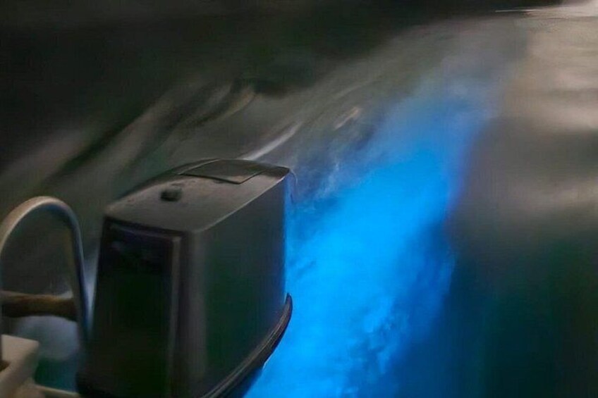 A vehicle interior with a blue light and a control panel. 3