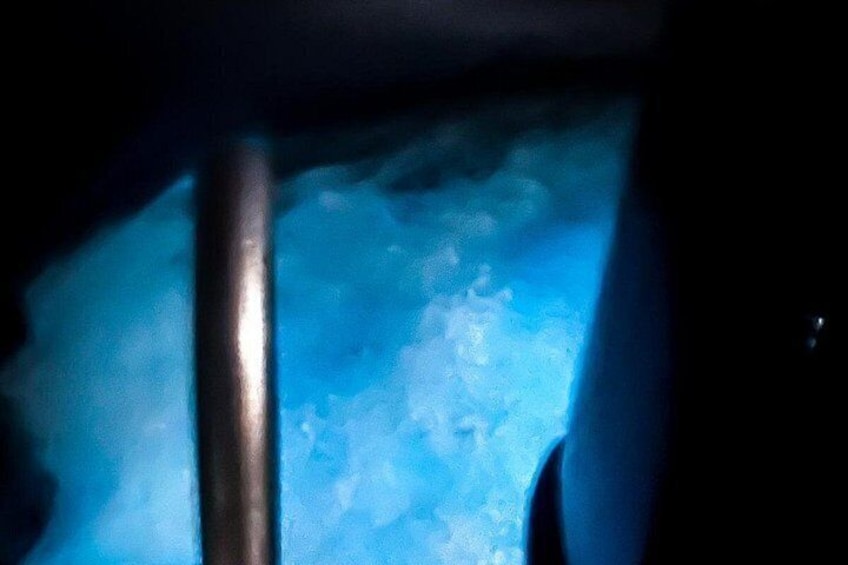 A close-up of a metallic pole and a blue, textured surface. 2
