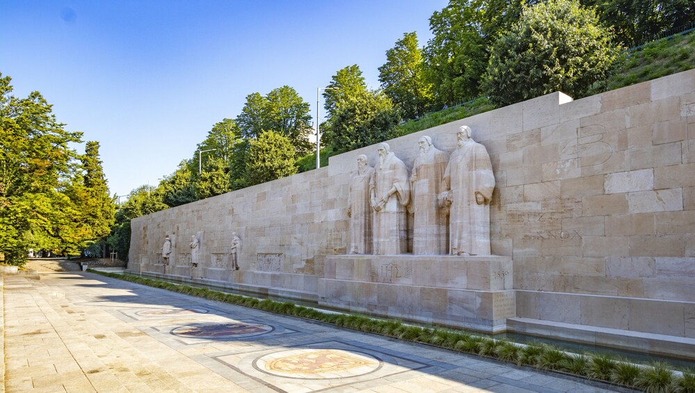 Un muro in pietra con statue e iscrizioni. 1
