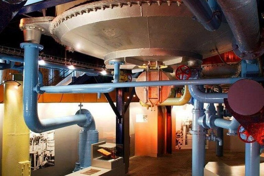 Industrial pipes, valves, and a large cylindrical tank. 2