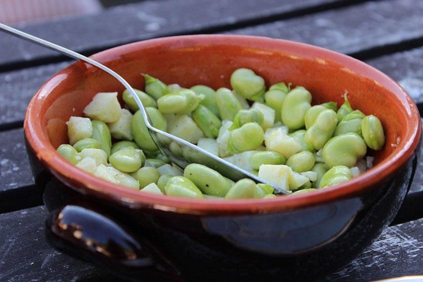 A bowl of green beans on a black surface. 2