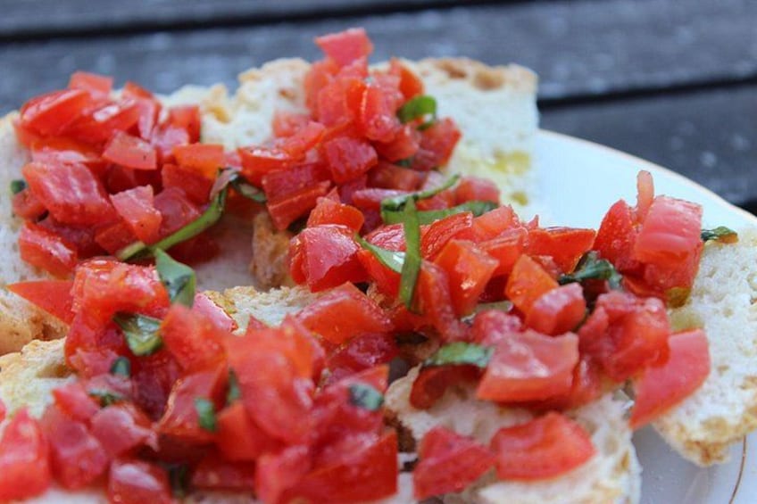A plate of bruschetta topped with diced tomatoes and basil. 5