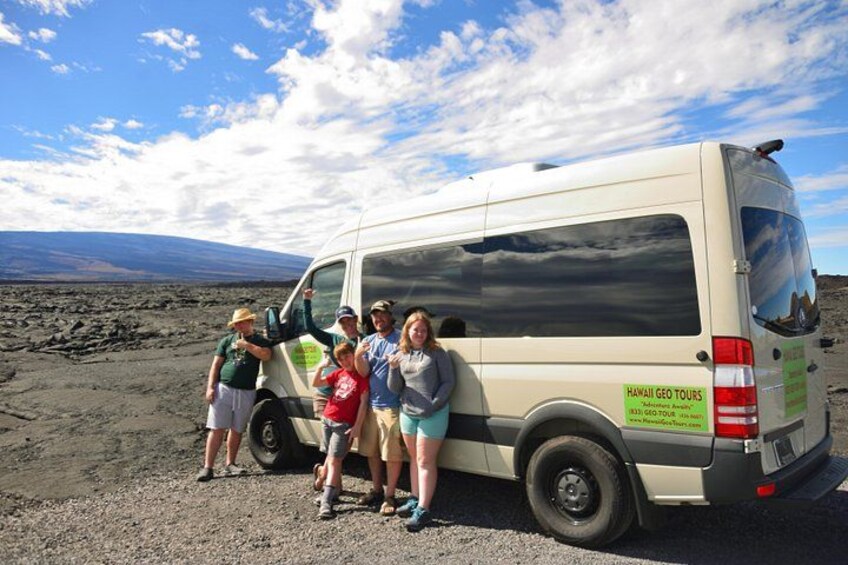 A group of people standing next to a van with a Hawaii Geo Tours logo. 2