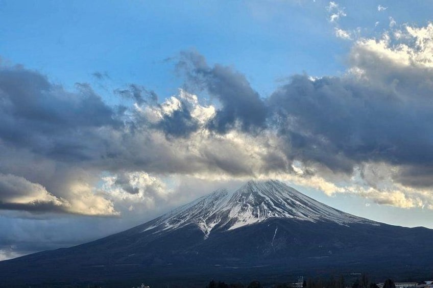 A snow-covered mountain with a clear sky and clouds. 3