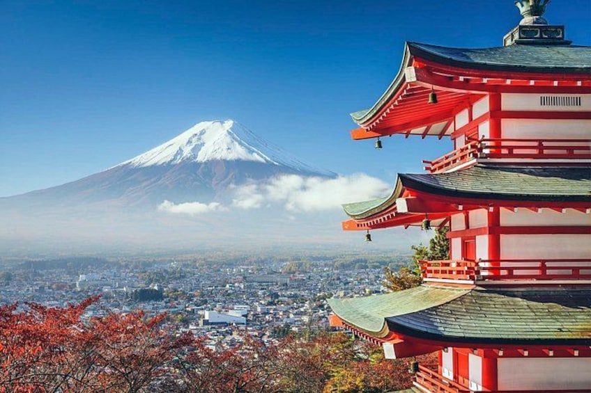 A snow-capped mountain, a traditional Japanese pagoda, and a cityscape in the foreground. 2