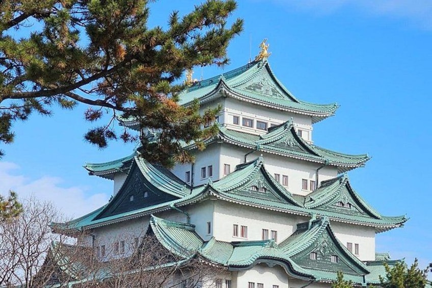 A traditional Japanese castle with multiple tiers and green roofs. 2
