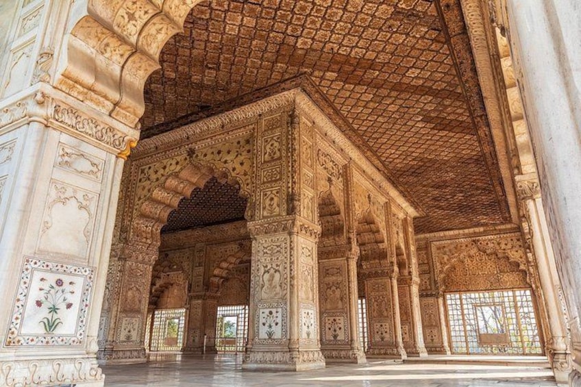 An ornate interior with intricate carvings and arches. 2