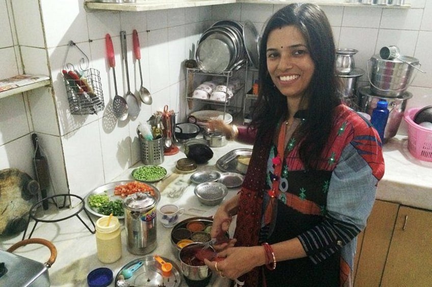 A person cooking in a kitchen with various utensils and ingredients. 1