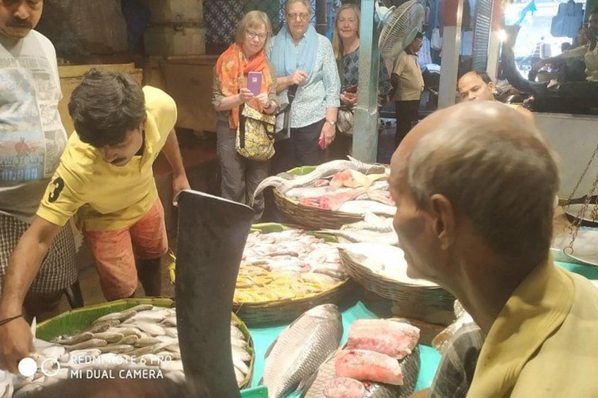 A market with people and fish on display. 3