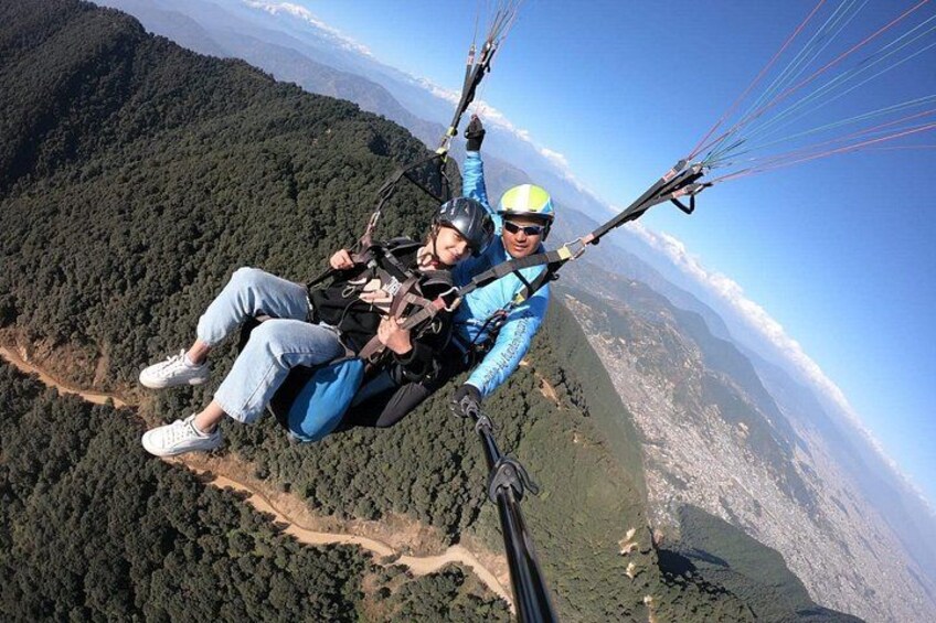A person paragliding over a mountainous landscape. 2