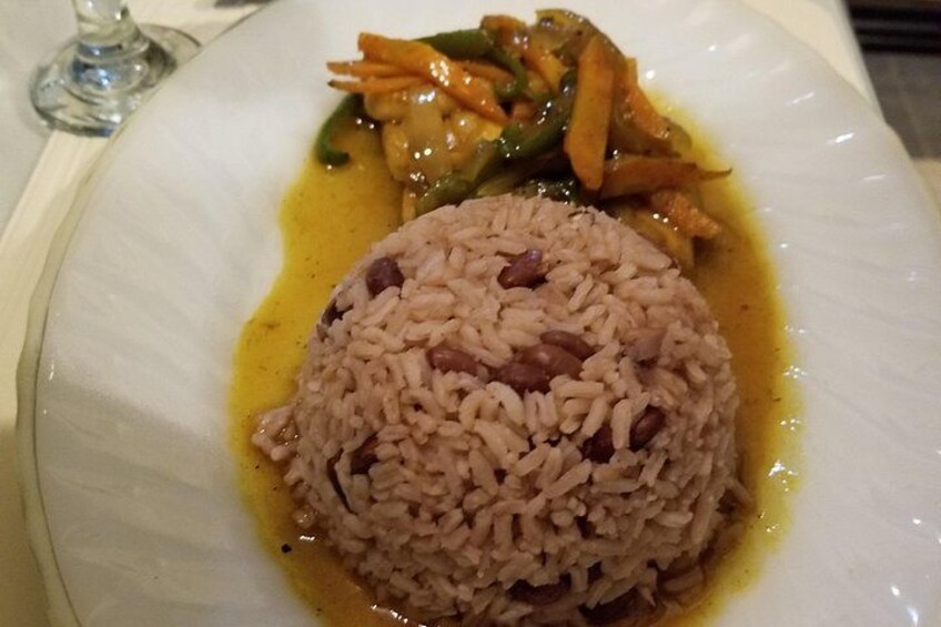 A plate of food with a mound of rice and a side of vegetables. 3