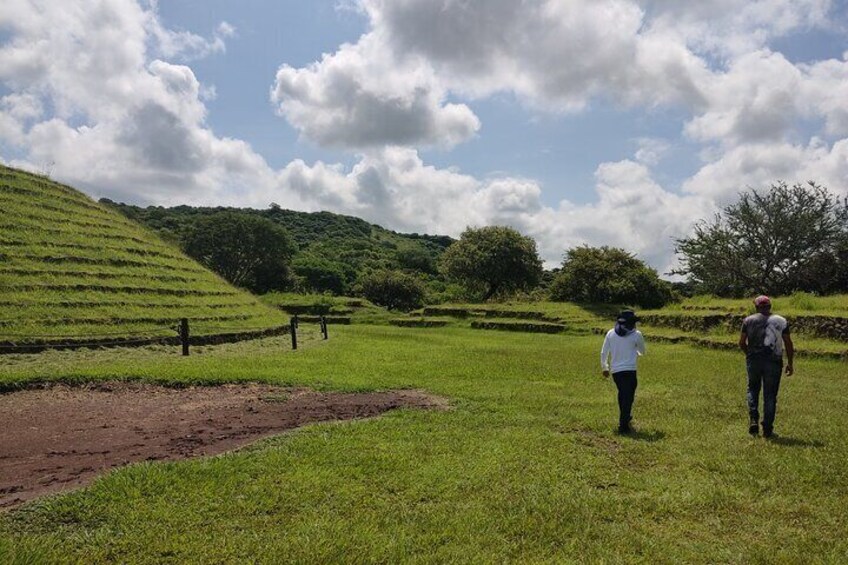 A hilly landscape with terraced fields and a clear sky. 1
