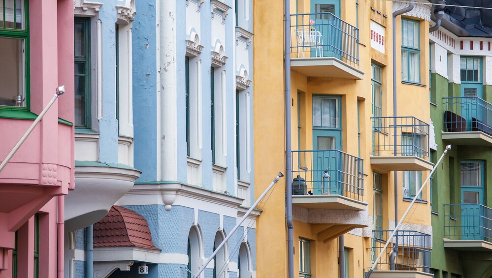 A row of colorful buildings with balconies and decorative railings. 1
