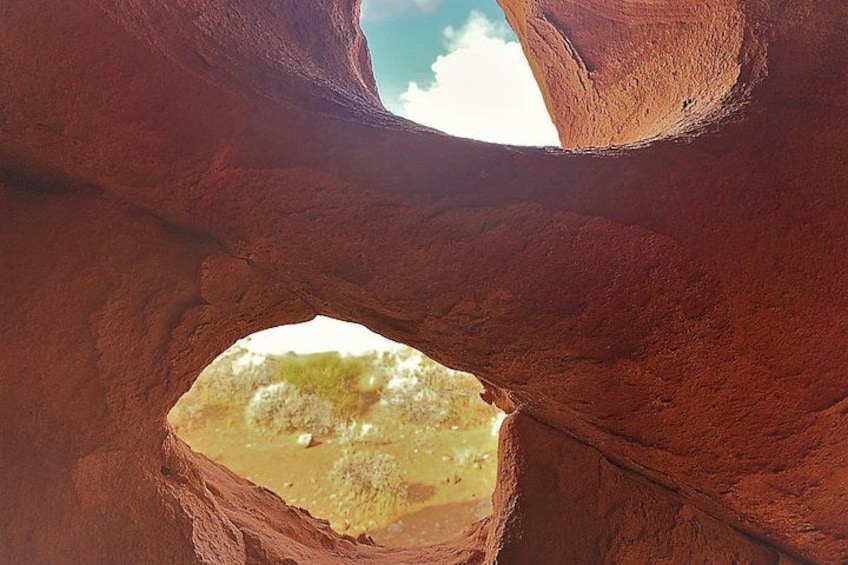 A natural rock formation with a circular opening. 4