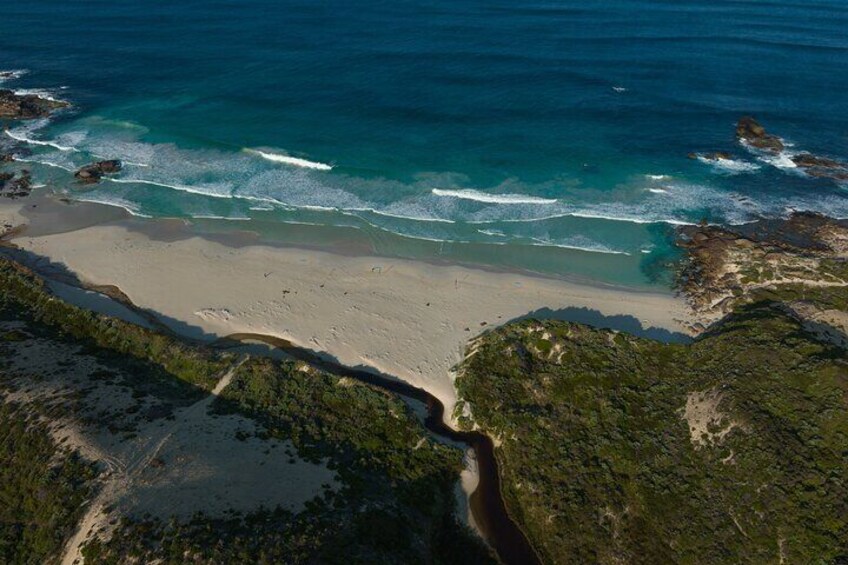 A majestic perspective of Redgate Beach from the sky. Behold the beauty of this coastal paradise from a breathtaking vantage point.