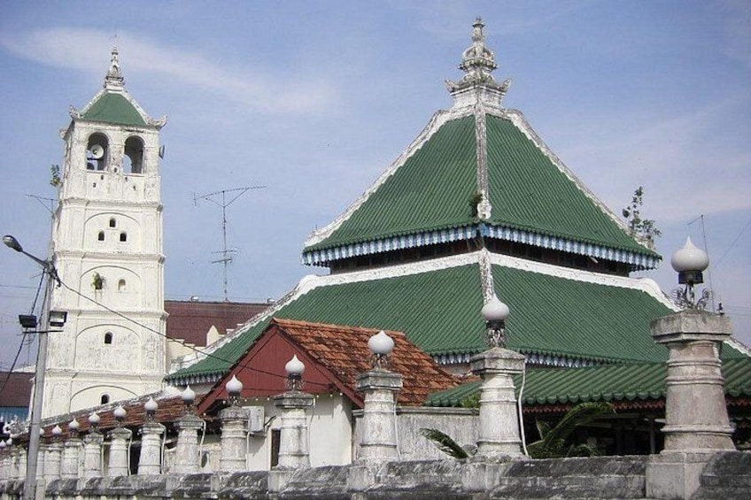 A traditional building with a green roof and a white tower. 3