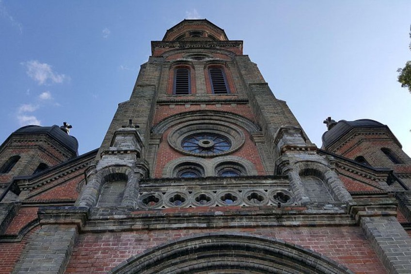 A church with a tall bell tower, arched windows, and a dome. 5