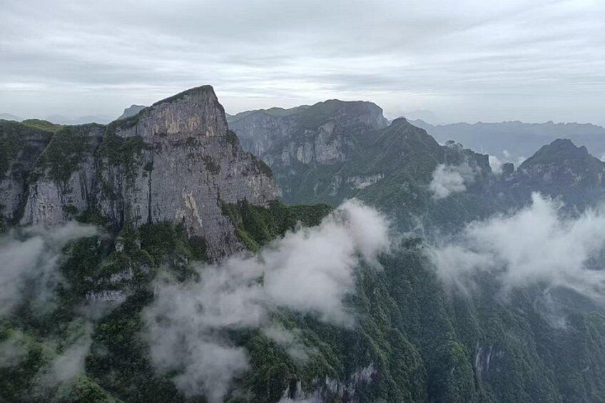 A mountainous landscape with prominent peaks and lush greenery. 3