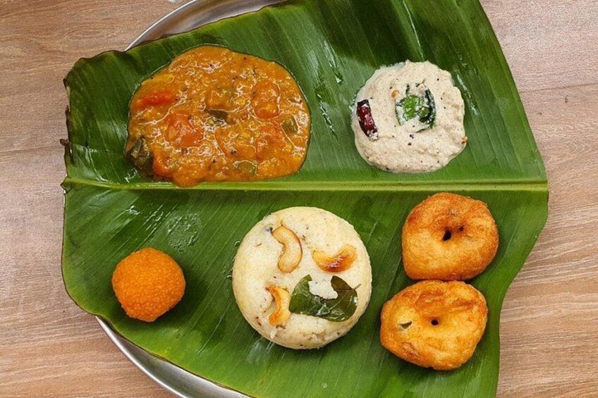 A variety of South Indian dishes on a banana leaf. 2