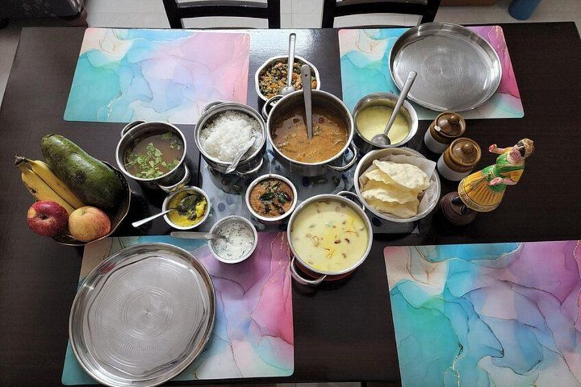 A table with various dishes and fruits, including a bowl of soup, a plate of rice, and a banana. 4
