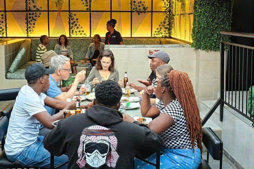 A group of people dining at a table in a restaurant with a modern interior design. 3