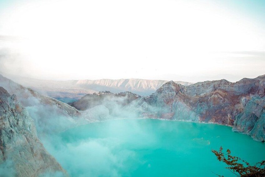 A turquoise hot spring surrounded by rugged mountains. 2