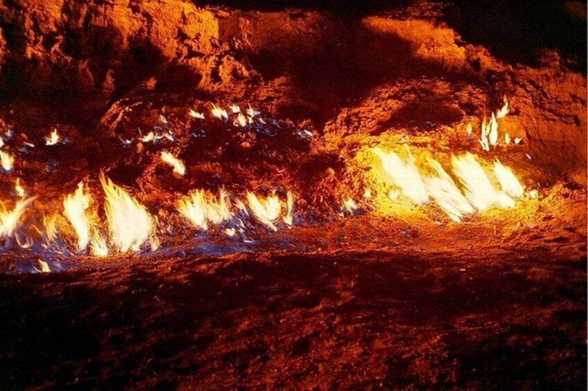 A cave with active lava flows and glowing orange and white lights. 2