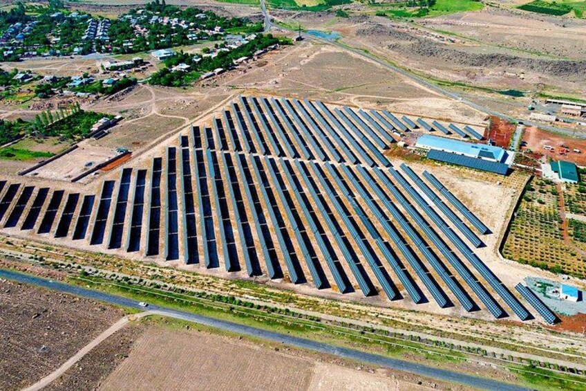 A large solar farm with rows of solar panels. 4