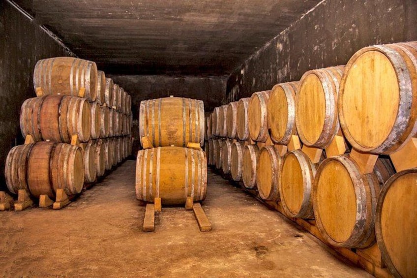 Wooden barrels stacked in a warehouse. 4