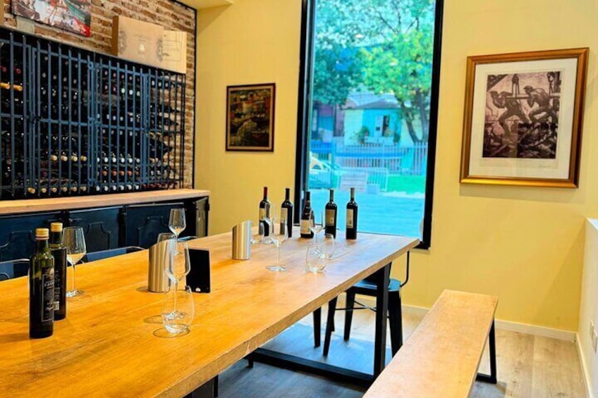 A wooden bar with wine bottles and glasses. 2