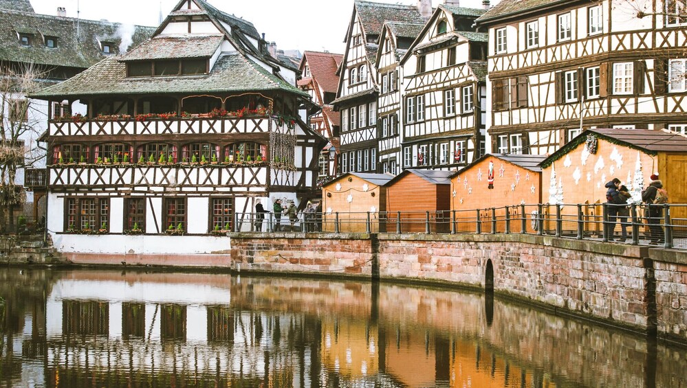 A traditional European town with half-timbered houses along a canal. 3