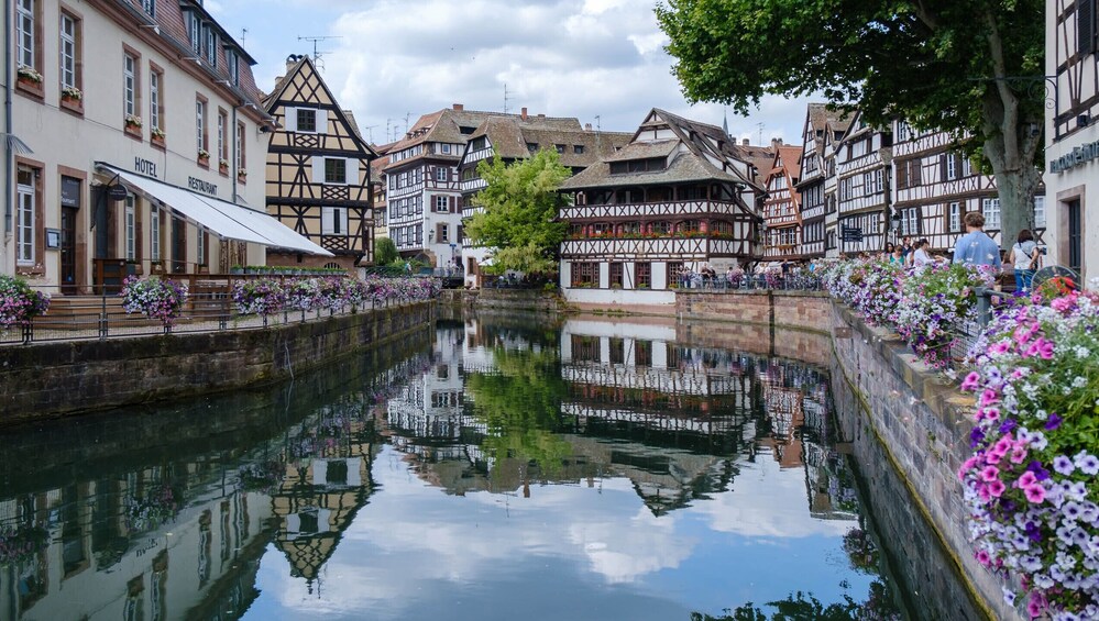A canal with buildings on either side, including a hotel and restaurant. 1