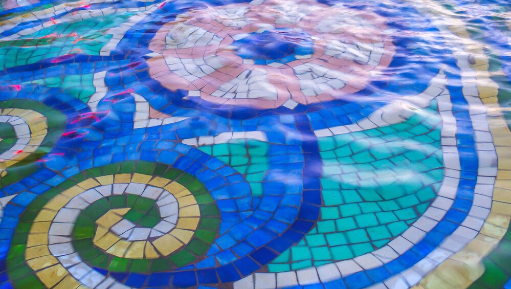 A mosaic with circular patterns and a spiral design. 3