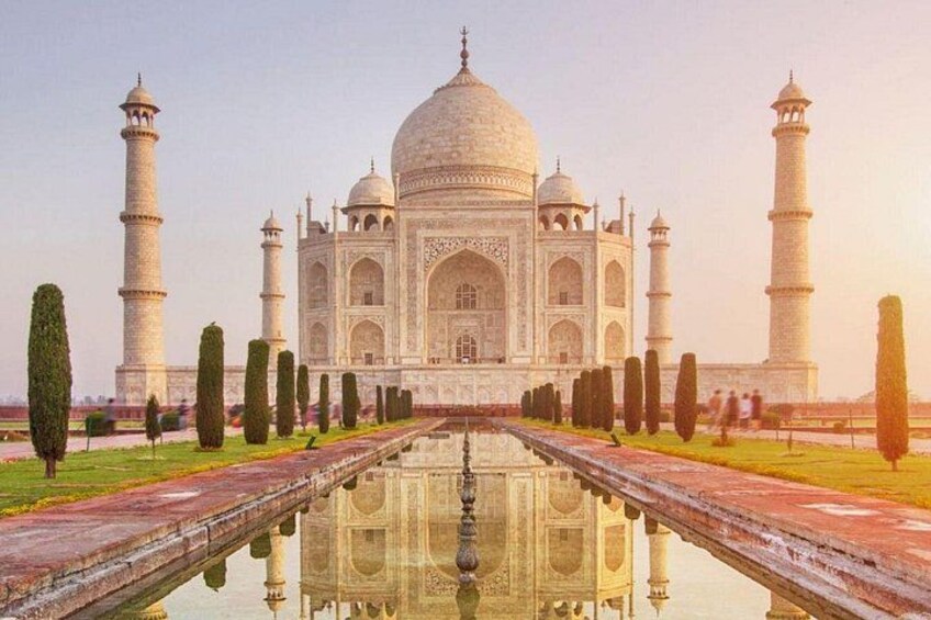 The Taj Mahal with its reflection in the water, four minarets, and a symmetrical garden. 2