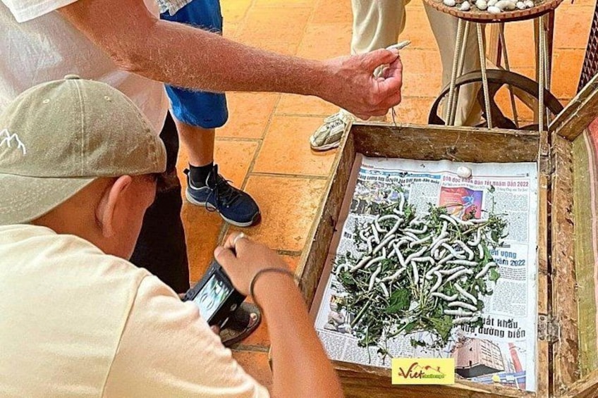 A person taking a photo of a newspaper with a picture of a plant on it. 5