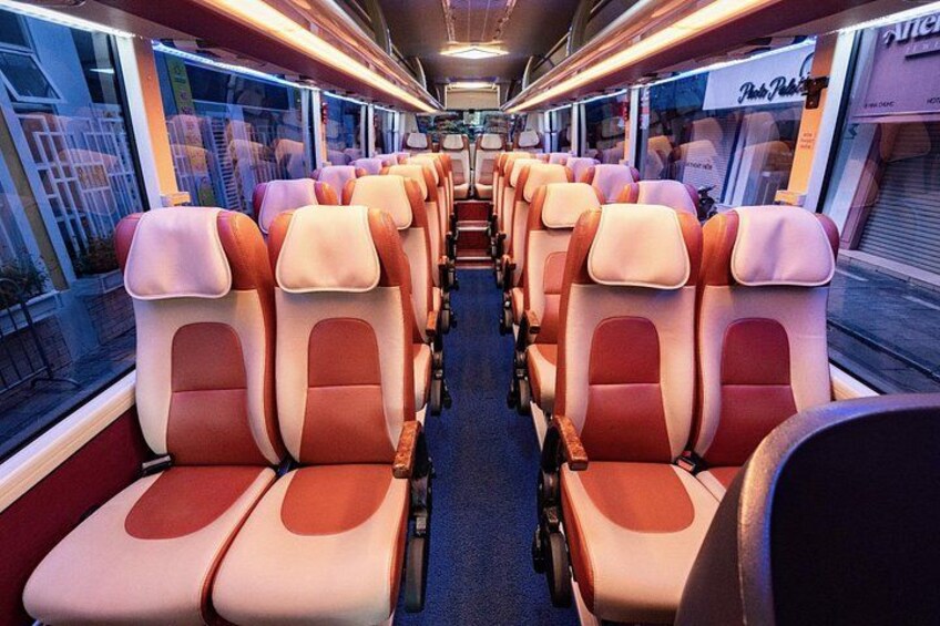 A train interior with rows of seats and windows. 2