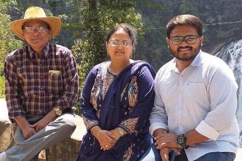 Three people sitting by a waterfall. 3