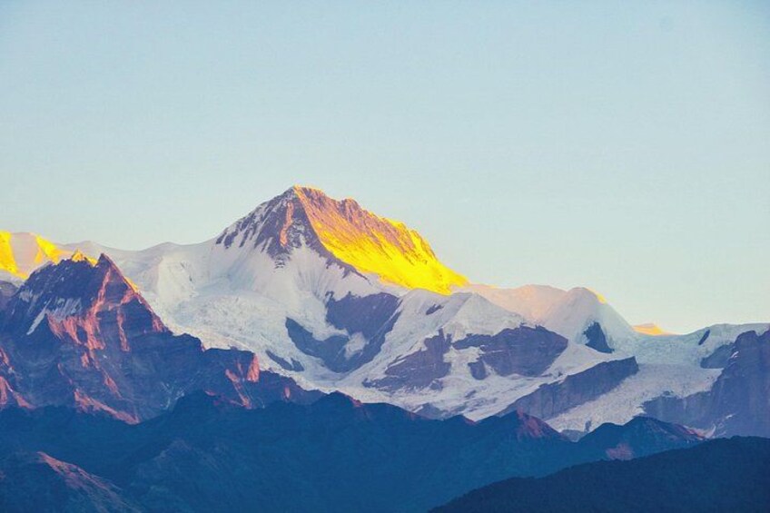 A mountain range with snow-capped peaks and a clear sky. 1
