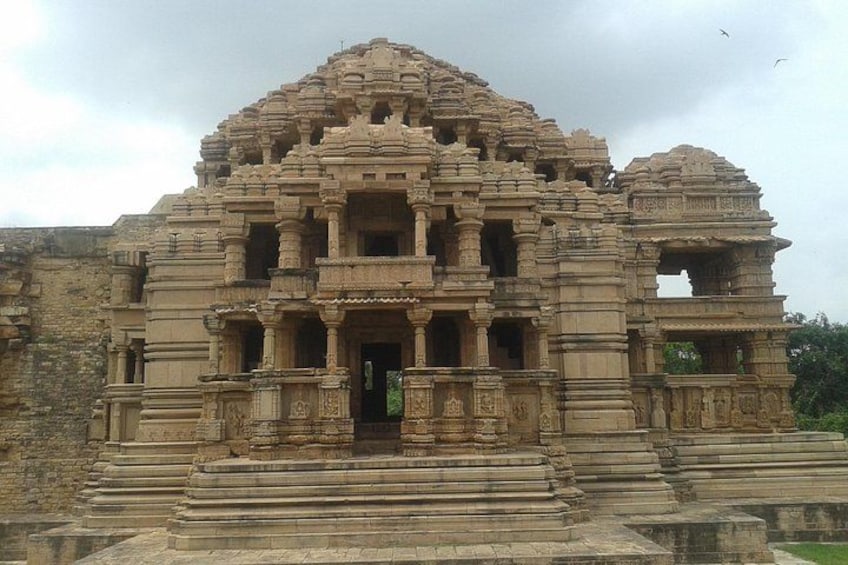 A large, intricately carved temple with multiple tiers and detailed stonework. 1