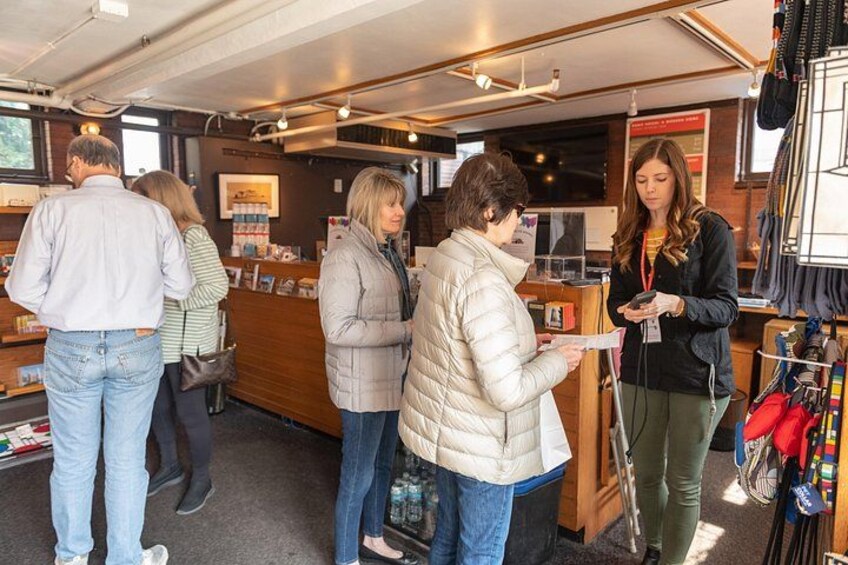 People in a store with shelves and a counter. 2