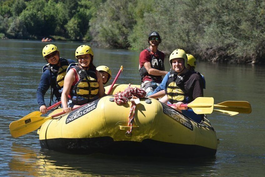 A group of people in a yellow raft on a river. 4