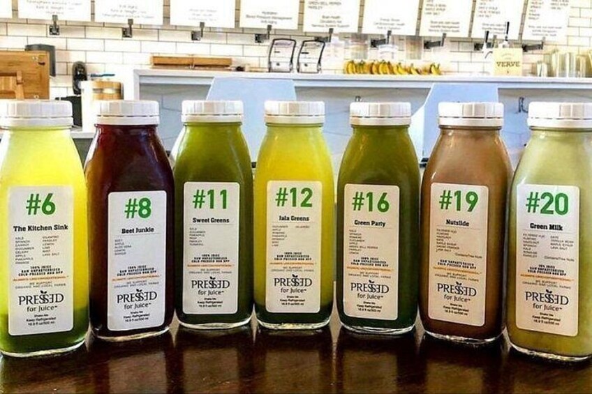 A row of juice bottles with labels indicating different flavors and numbers. 4